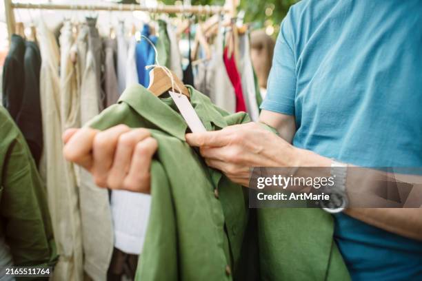 senior man shopping at a local or flea market. sustainable lifestyle and zero waste concept. - prislapp bildbanksfoton och bilder