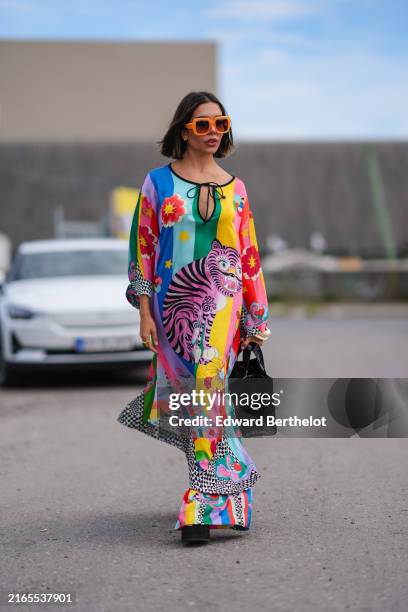 Guest wears orange sunglasses, silver earrings, bright multi-colored Manoush crazy tiger long sleeve dress, bright multi-colored Manoush crazy tiger...