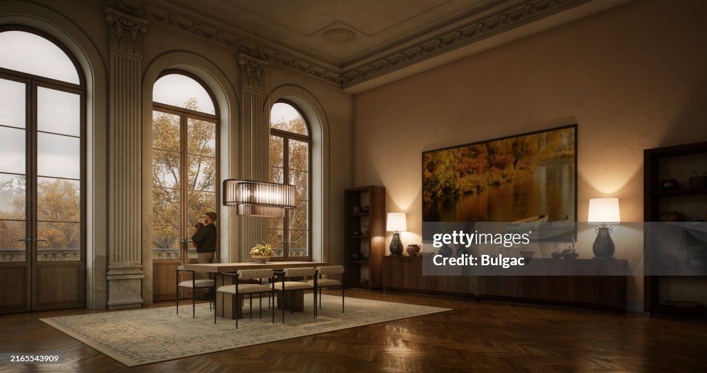 Elegant Dining Room with Large Arched Windows Overlooking Autumn Foliage