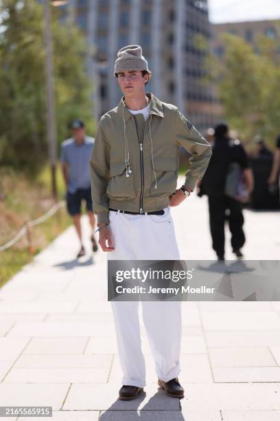 Ben Heckler is seen wearing a grey beanie, a olive Harrington jacket from Moose Knuckles with a white tee underneath, several bracelets and a watch,...