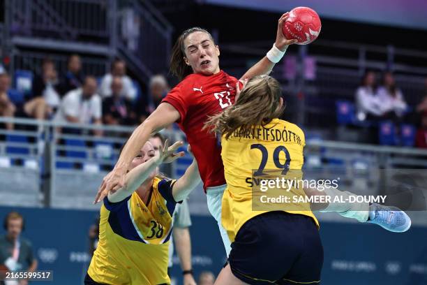 Denmark's right back Louise Vinter Burgaard jumps to shoot during the women's Bronze Medal handball match between Denmark vs Sweden of the Paris 2024...