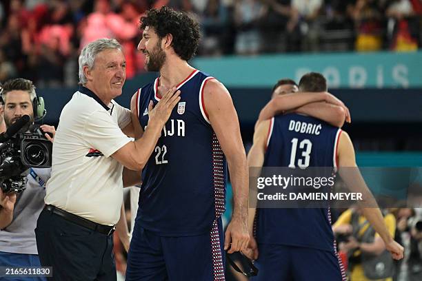 Serbia's coach Svetislav Pesic congratulates Serbia's Vasilije Micic after Serbia won the men's Bronze Medal basketball match between Germany and...