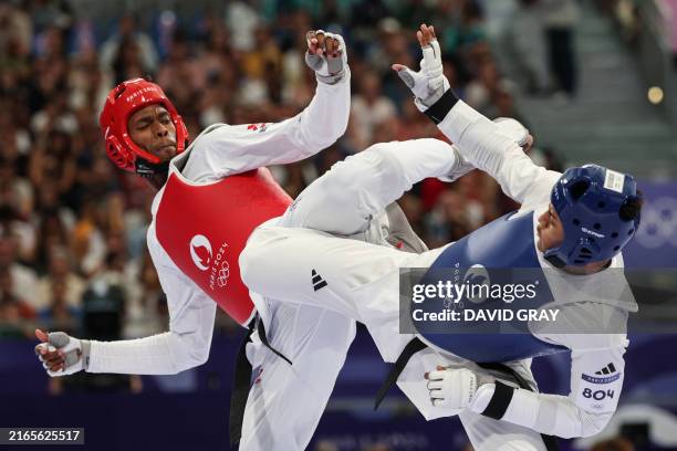 Cuba's Rafael Alba competes against Britain's Caden Cunningham in the taekwondo men's +80kg quarter-final bout of the Paris 2024 Olympic Games at the...
