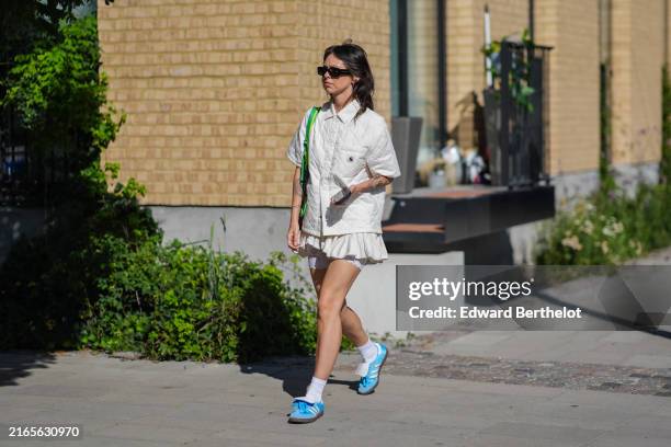 Guest wears black sunglasses, cream quilted Carhartt oversized short sleeve shirt, lime green bag, cream puffy mini skirt, white mini lace biker...