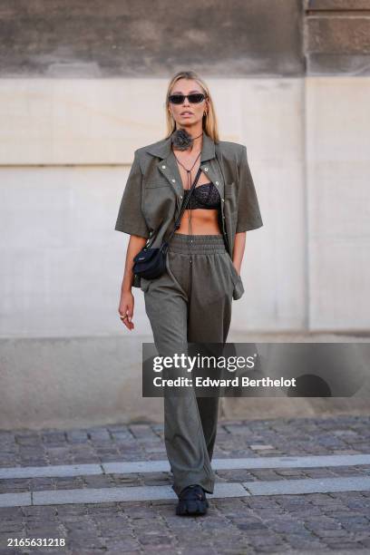 Guest wears black sunglasses, dark gray floral choker necklace, dark green oversized blazer short sleeve shirt, black lace bralette, black leather...