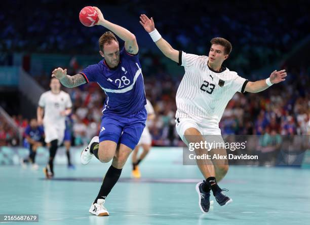 Valentin Porte of Team France runs with the ball whilst being challenged by Renars Uscins of Team Germany during the Men's Quarterfinal match between...