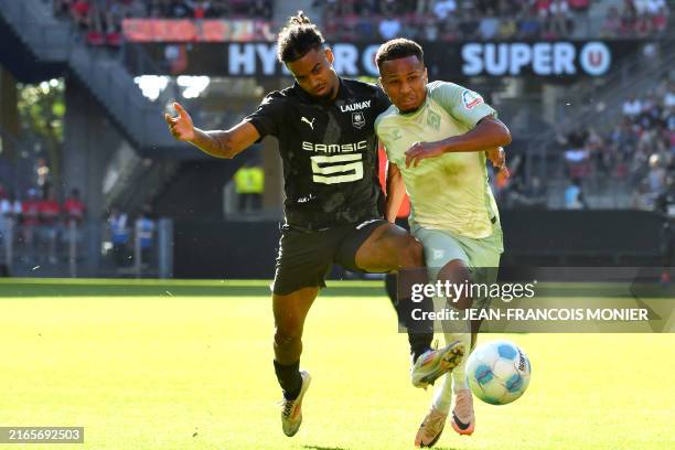 Rennes' French defender Lorenz Assignon and Bremen's German defender Felix Agu fight for the ball during the pre-season friendly match between Stade...