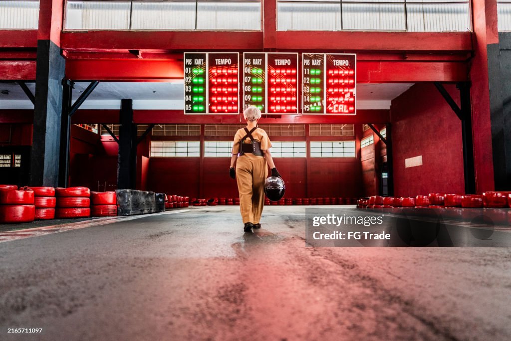 Senior woman walking on a go-kart track