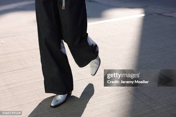 Laura Schulte is seen wearing wide dark blue jeans, and pointed silver Chelsea boots from Copenhagen Studios CPH247 leather silver on August 06 in...