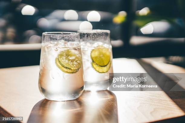 summer cold drink, lemonade on table in sunny day. - tonic water stock pictures, royalty-free photos & images