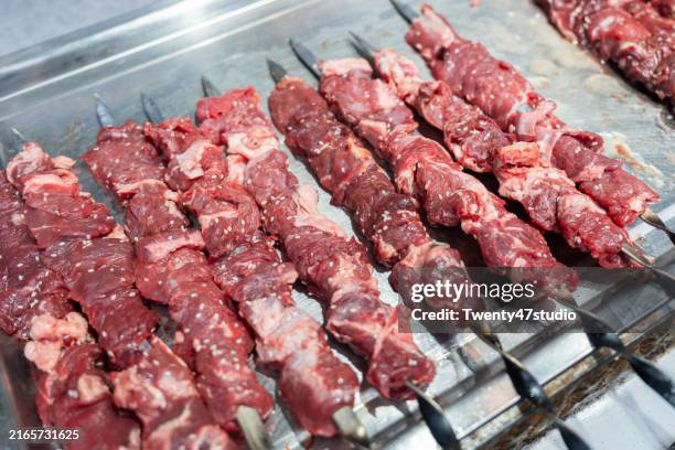 camel meat barbecue skewers at a xinjiang market - skewer stock pictures, royalty-free photos & images