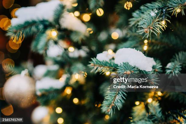 christmas ball on christmas tree with snow. winter season, christmas and new year holidays background. - tradizione foto e immagini stock