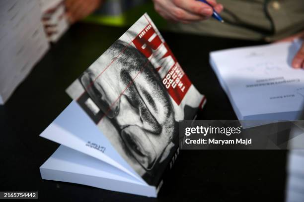 Ilya Yashin, a Russian dissident who was recently released as part of a prisoner swap, signs his book during a visit to speak to media on August 07,...