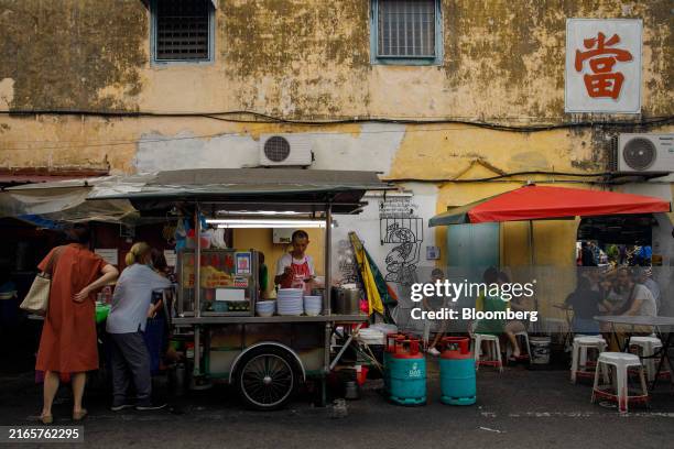 Customers at street foods stall in Georgetown, Penang, Malaysia, on Tuesday, Aug. 6, 2024. Malaysia is scheduled to release gross domestic product...