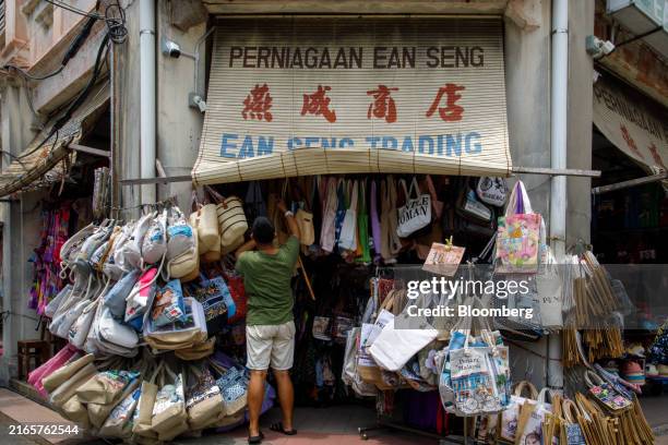 Vendor arranges bags displayed outside his shop in Georgetown, Penang, Malaysia, on Tuesday, Aug. 6, 2024. Malaysia is scheduled to release gross...