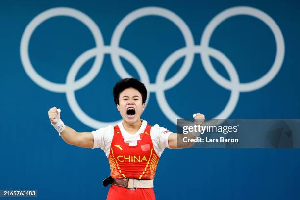 Zhihui Hou of Team People's Republic of China celebrates breaking the Olympic record during the Weightlifting Women's 49kg on day twelve of the...