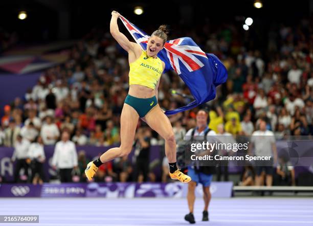 Nina Kennedy of Team Australia celebrates winning the gold medal after competing in the Women's Pole Vault Final on day twelve of the Olympic Games...