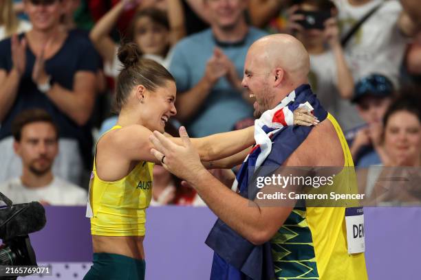 Women's Pole Vault gold medalist Nina Kennedy of Team Australia celebrates with Men's Discus Throw bronze medalist Matthew Denny of Team Australia on...