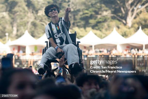 Spectator in a wheelchair crowdsurfs and is acknowledged by ScHoolboy Q as he performs at Outside Lands in San Francisco on Saturday, Aug. 10, 2024.