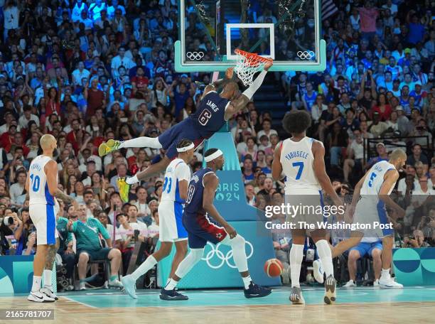 Paris, France United States guard Lebron James dunks the ball during the men's basketball final against France held at Bercy Arena at the 2024 Summer...