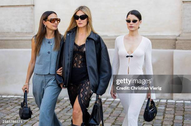 Anna Winter wears denim pants, vest, black bag & Alessa Winter wears black leather jacket, transparent dress with slit, boots & Lea Naumann wears...