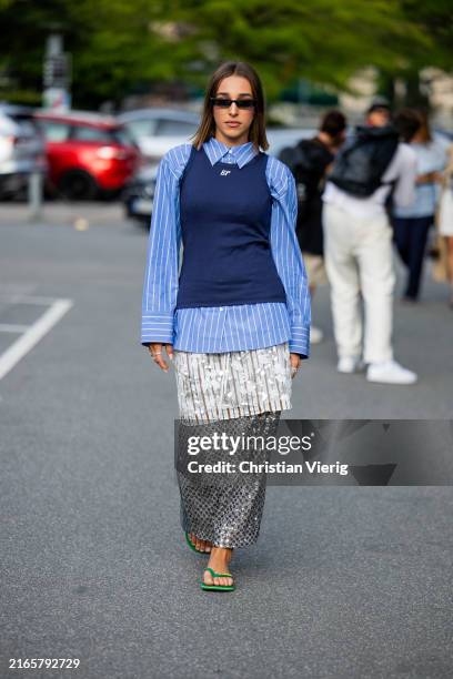 Ginevra Mavilla wears blue white button shirt, sleeveless shirt, silver skirt, Flip Flops Havaianas outside Baum & Pferdgarten during day three of...
