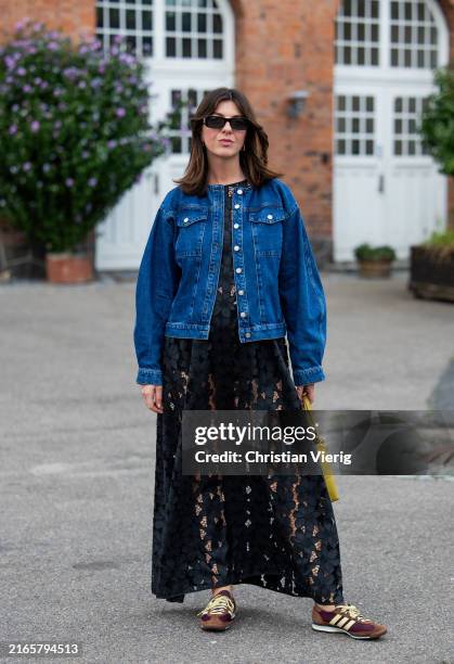 Francesca Saffari wears denim jacket, black laced skirt, yellow bag outside Baum & Pferdgarten during day three of the Copenhagen Fashion Week SS25...