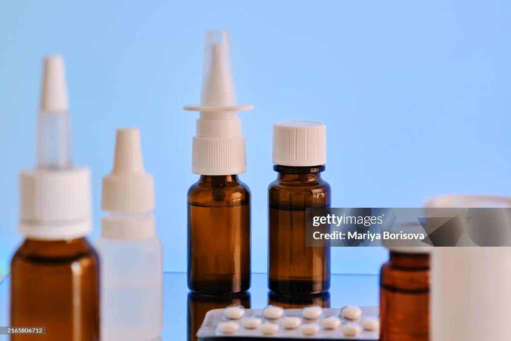 The photo shows drops, spray, tablets and other medications on a blue background.
