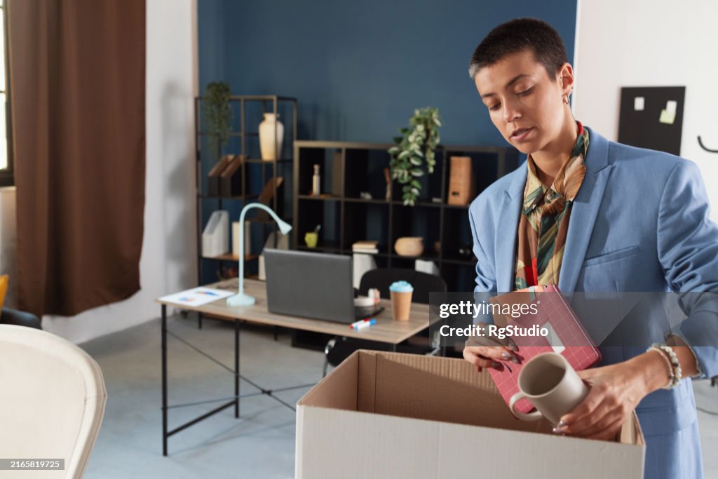 Businesswoman packing her staff from the office desk