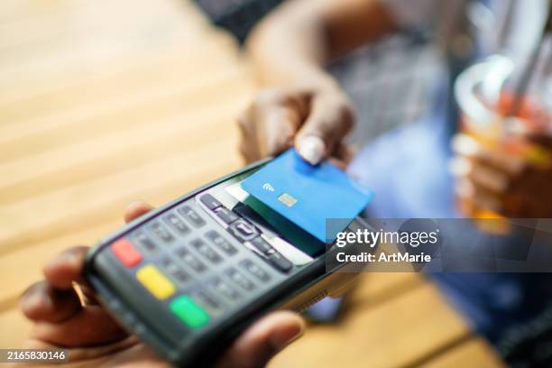 young woman paying with credit card in a cafe - credit card art stock pictures, royalty-free photos & images
