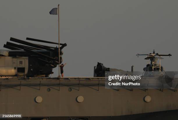 Crew members stand aboard the amphibious assault ship USS Wasp docked at Limassol Port, amid rising tensions in the Middle East, in Limassol, Cyprus,...