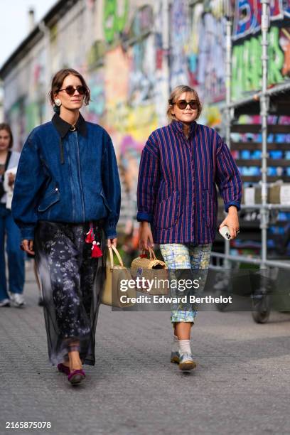 Guest wears red sunglasses, gold earrings, navy blue denim jean oversized jacket, black skirt sheer mesh floral pattern.print pants, dark purple...