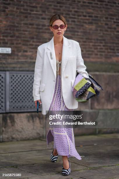 Guest wears red sunglasses, gray tied top, white oversized blazer jacket, light purple sheer mesh midi skirt, green pink lime green and light purple...