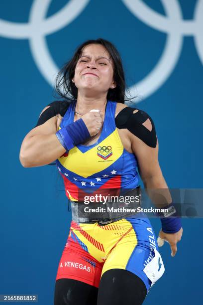 Anyelin Venegas Valera of Team Venezuela reacts while performing a Clean & Jerk during the Weightlifting Women's 59kg on day thirteen of the Olympic...