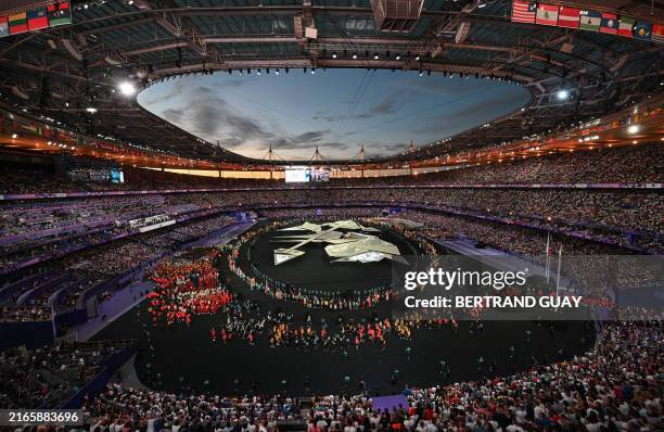 Athletes take part in the athletes parade during the closing ceremony of the Paris 2024 Olympic Games at the Stade de France, in Saint-Denis, in the...
