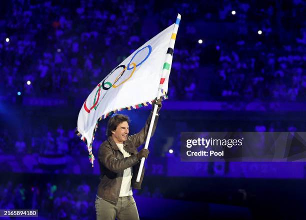 Actor Tom Cruise holds the Olympic flag during the Closing Ceremony of the Olympic Games Paris 2024 at Stade de France on August 11, 2024 in Paris,...