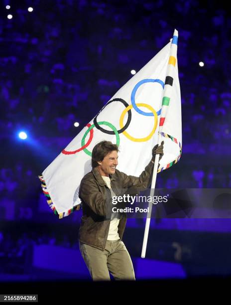 Actor Tom Cruise holds the Olympic flag during the Closing Ceremony of the Olympic Games Paris 2024 at Stade de France on August 11, 2024 in Paris,...