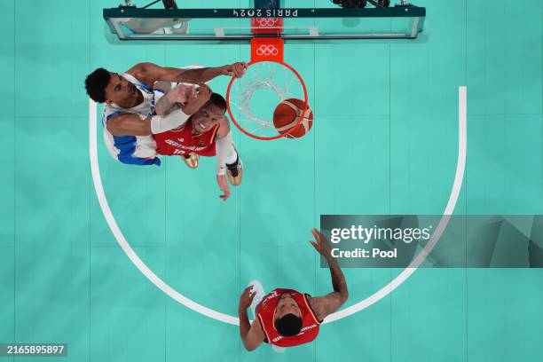 Victor Wembanyama of Team France dunks over Daniel Theis of Team Germany during a Men's basketball semifinals match between Team France and Team...