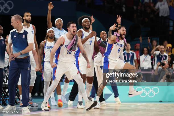 Nando de Colo, Guerschon Yabusele, Isaia Cordinier of Team France react from the bench after a basket during a Men's basketball semifinals match...