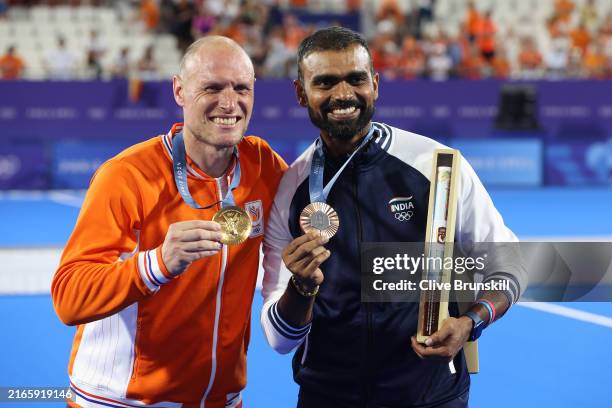 Gold medalist, Pirmin Blaak of Team Netherlands and Bronze medalist, Sreejesh Parattu Raveendran of Team India pose for a photo with their medals...