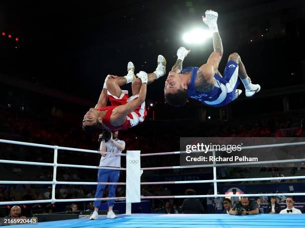 Abdumalik Khalokov of Team Uzbekistan and Charlie Senior of Team Australia perform synchronised back flips after the Boxing Men's 57kg Semifinal...