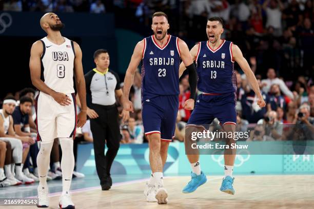 Derrick White of Team United States looks on while Marko Guduric and Ognjen Dobric of Team Serbia celebrate after a three point basket during a Men's...