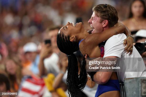 Tara Davis-Woodhall of Team United States celebrates with her husband Hunter Woodhall after winning the gold medal in the Women's Long Jump Final on...