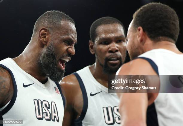 LeBron James, Kevin Durant, and Stephen Curry of Team United States celebrate after their team's win against Team Serbia during a Men's basketball...