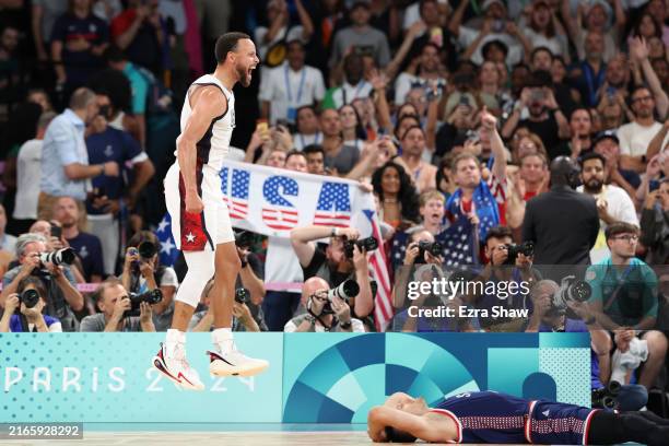 Stephen Curry of Team United States celebrates while Aleksa Avramovic of Team Serbia reacts after Team United States' victory against Team Serbia...