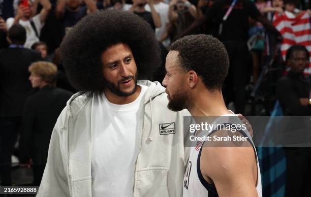 Former NFL player Colin Kaepernick talks with Stephen Curry of Team United States after Team United States' win against Team Serbia during a Men's...