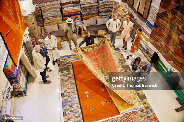 Syrian Rug Salesman Extreme Wide Overhead Shot Salesman Opening Rug For Customers At Shop ...