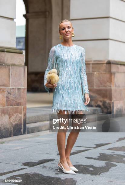 Josefien Weyns wears turquoise dress, yellow bag outside Rotate during day four of the Copenhagen Fashion Week SS25 on August 08, 2024 in Copenhagen,...