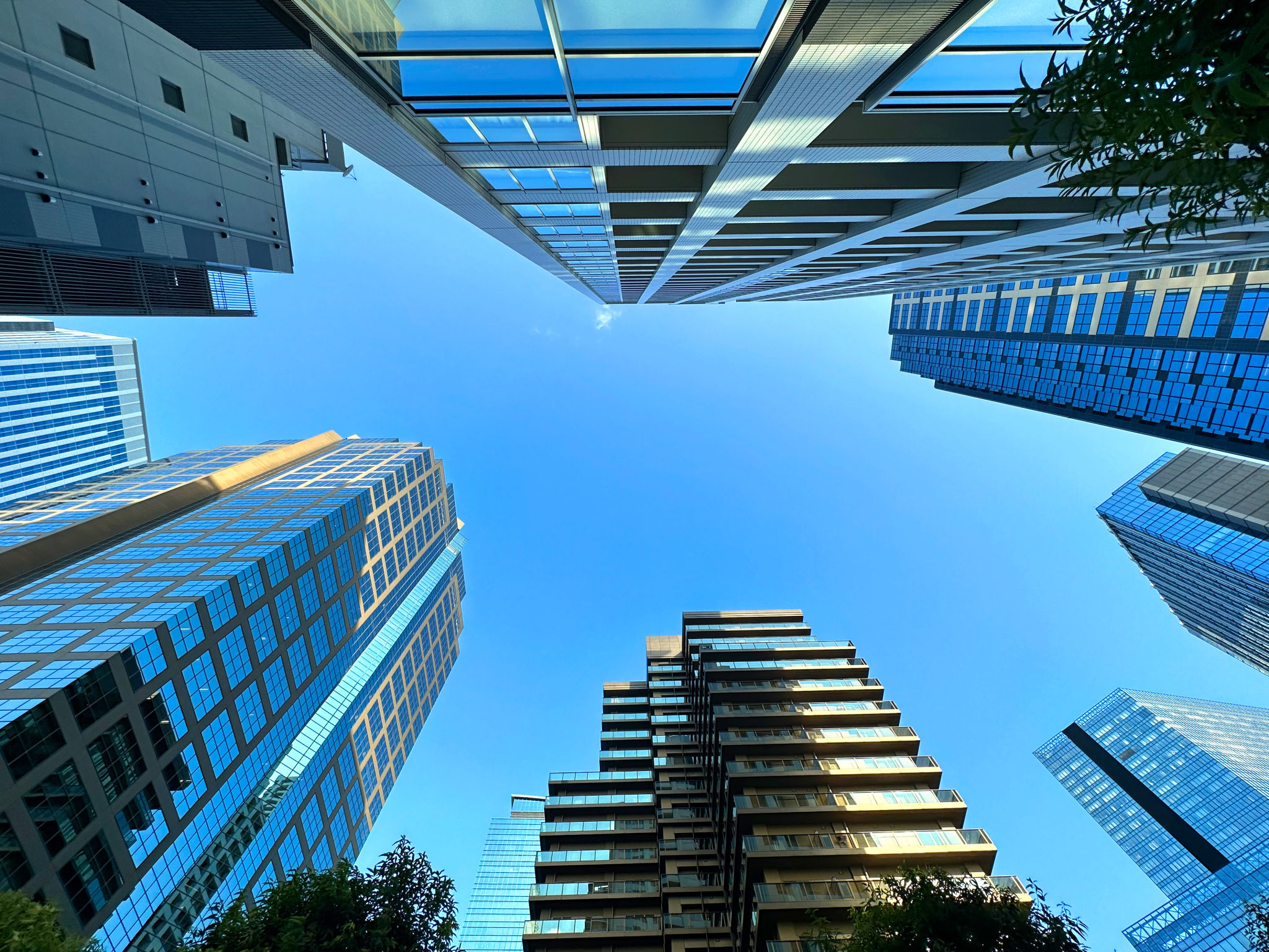High-rise apartment building in the city and blue sky, daytime, looking up High-rise apartment building in the city and blue sky, daytime, looking up