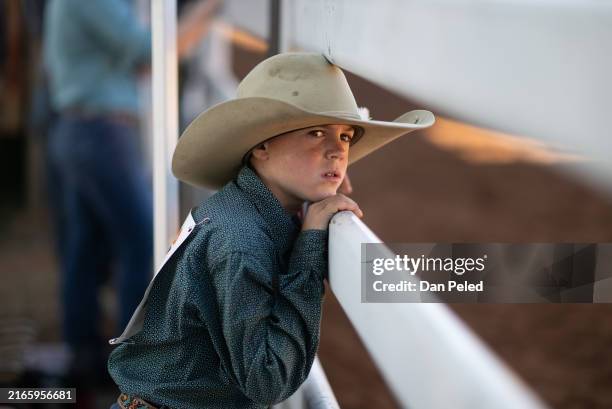 Young competitor watches events at the Mount Isa Mines Rodeo on August 09, 2024 in Mount Isa, Australia. The 2024 Mount Isa Mines Rodeo, Australia's...